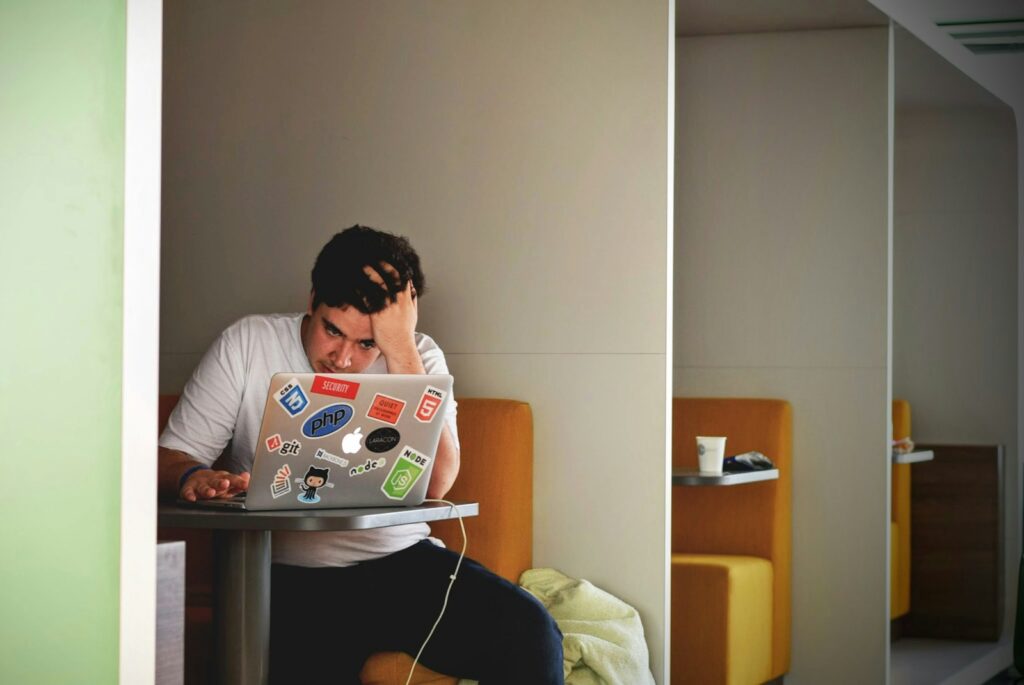 Un ragazzo che scrive la tesi di laurea con ansia e stress